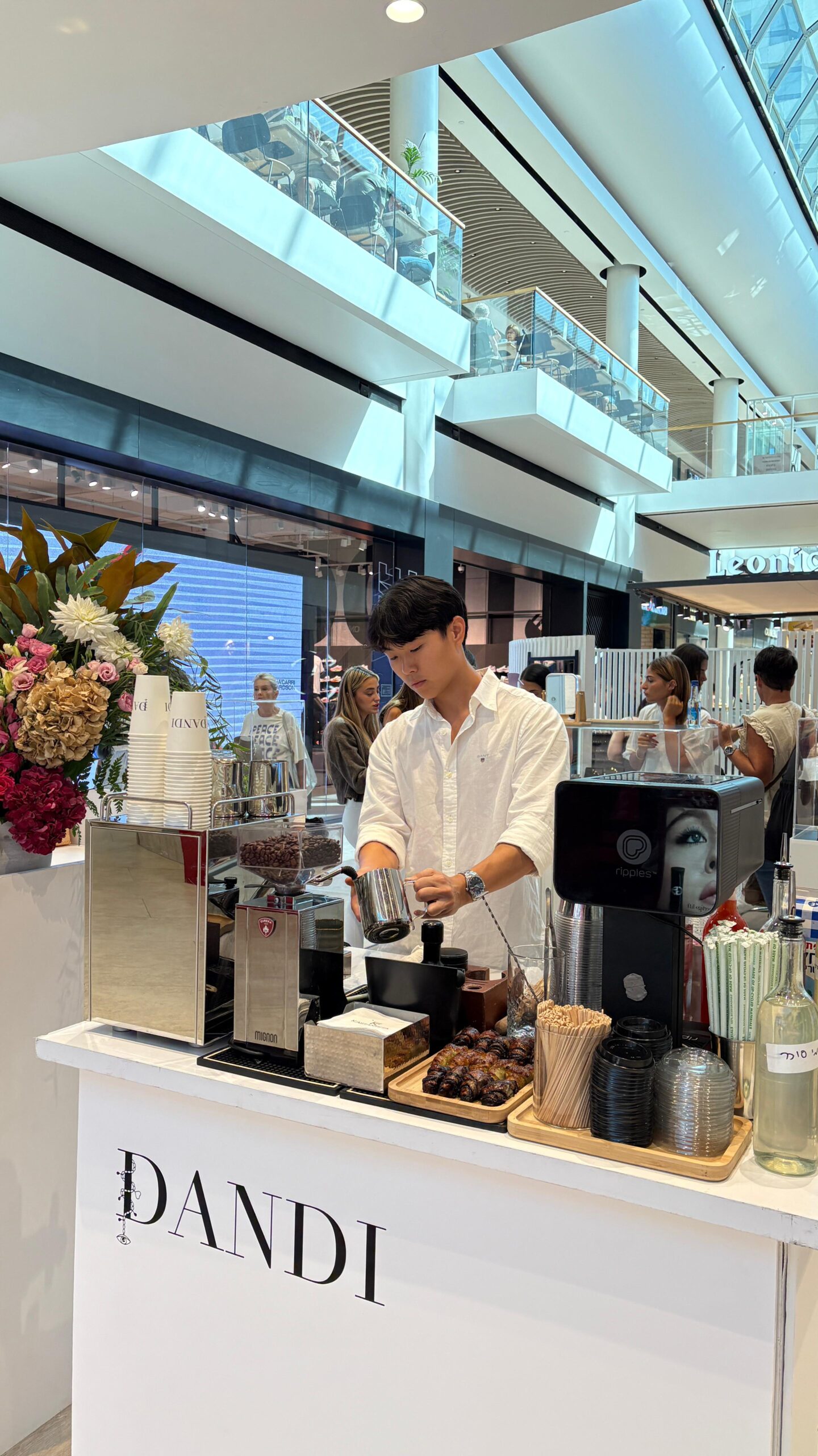 An asian man making coffee